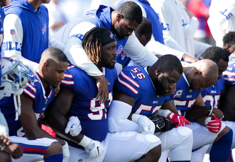 Buffalo Bills players kneel during the national anthem before an NFL game against the Denver Broncos