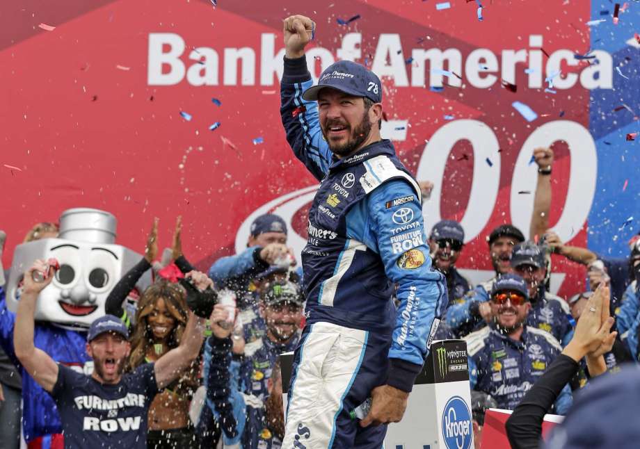 Martin Truex Jr celebrates in Victory Lane after winning a NASCAR Cup Series auto race at Charlotte Motor Speedway in Concord N.C. Sunday Oct. 8 2017