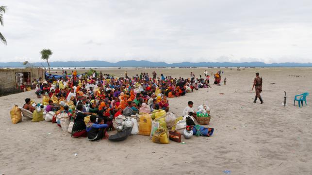 Rohingya refugees wait at a Border Guard Bangladesh post after crossing the Bangladesh Myanmar border by boat through the Bay of Bengal in Shah Porir Dwip. Reuters