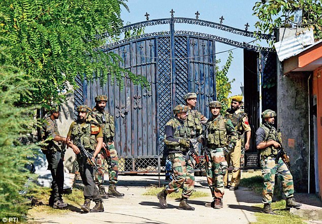 Security personnel take positions during an operation after militants stormed a BSF camp early morning near Srinagar International Airport