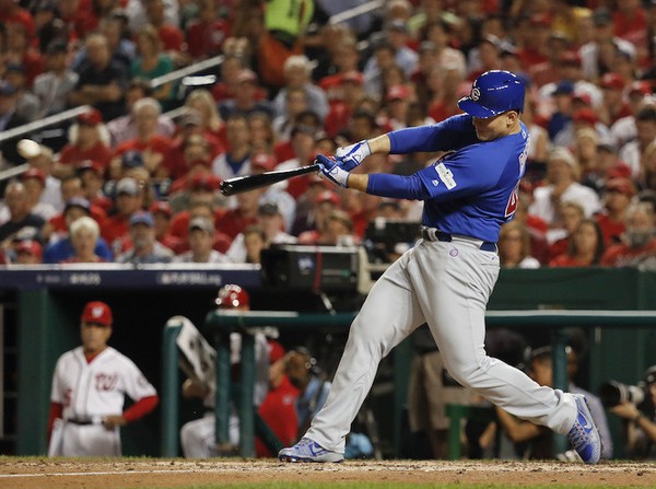 Chicago Cubs Anthony Rizzo hits a single off Washington Nationals starting pitcher Stephen Strasburg to score teammate Kris Bryant in the sixth inning in Game 1 of baseball's National League Division Series at Nationals Park Friday Oct. 6 2017 in Wa