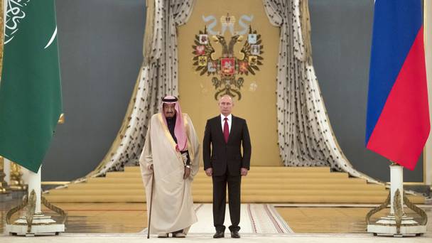 Vladimir Putin right and Saudi King Salman listen to national anthems during their meeting in the Kremlin