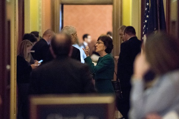 Sen. Susan Collins of Maine right speaks with fellow Republican Sen. Rob Portman of Ohio left as Republican senators gathered to meet with Senate Majority Leader Mitch Mc Connell of Kentucky on the GOP tax bill Friday prior to the Senate's passage of