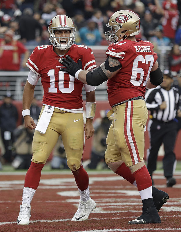 San Francisco 49ers quarterback Jimmy Garoppolo celebrates after scoring a touchdown with center Daniel Kilgore during the first half of an NFL football game against the Jacksonville Jaguars in Santa Clara Calif. Sunday Dec. 24 2017. (AP Pho