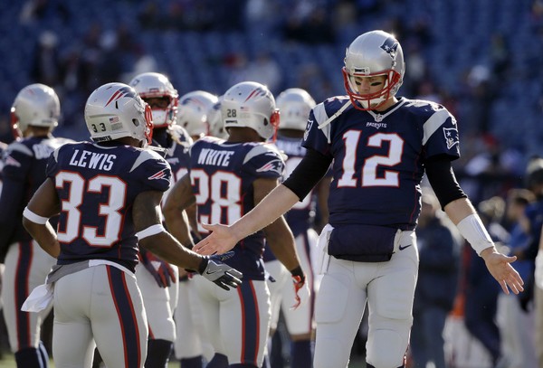 New England Patriots quarterback Tom Brady slaps hands with running back Dion Lewis before an NFL football game against the Los Angeles Rams Sunday Dec. 4 2016 in Foxborough Mass