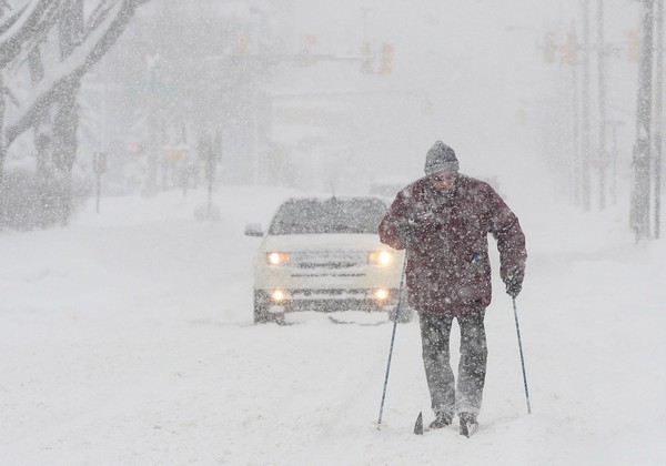 Timothy Gigone 51 of Erie Pa. skis south on Sassafras Street near the intersection of West 14th Street Saturday Dec. 30 2017