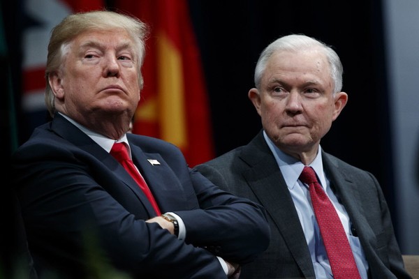 President Donald Trump sits with Attorney General Jeff Sessions during the FBI National Academy graduation ceremony in Quantico Va