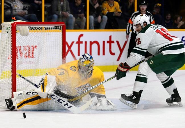 Nashville Predators goalie Juuse Saros makes a save against Minnesota Wild forward Jason Zucker in the first period of an NHL hockey game Saturday Dec. 30 2017 in Nashville Tenn