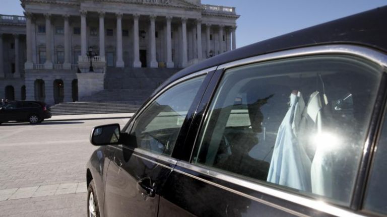 Extra shirts hang inside of a senator's vehicle