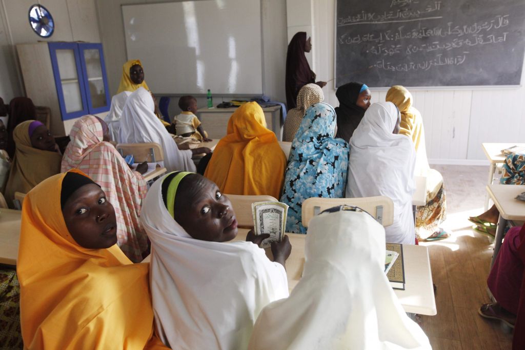 Children displaced by Boko Haram during an attack on their villages receive lectures in a Nigerian school | AP