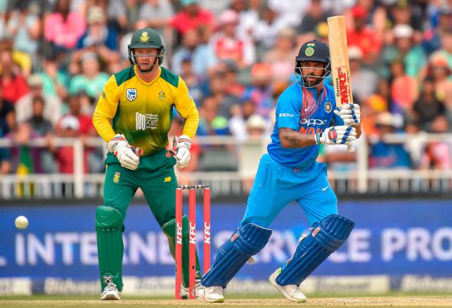 India`s batsman Shikhar Dhawan is watched by South Africa`s wicketkeeper Heinrich Klaasen as he plays a shot during the first T20I cricket match between South Africa and India at The Wanderers Cricket Stadium in Johannesburg on 18 February 2018. Phot