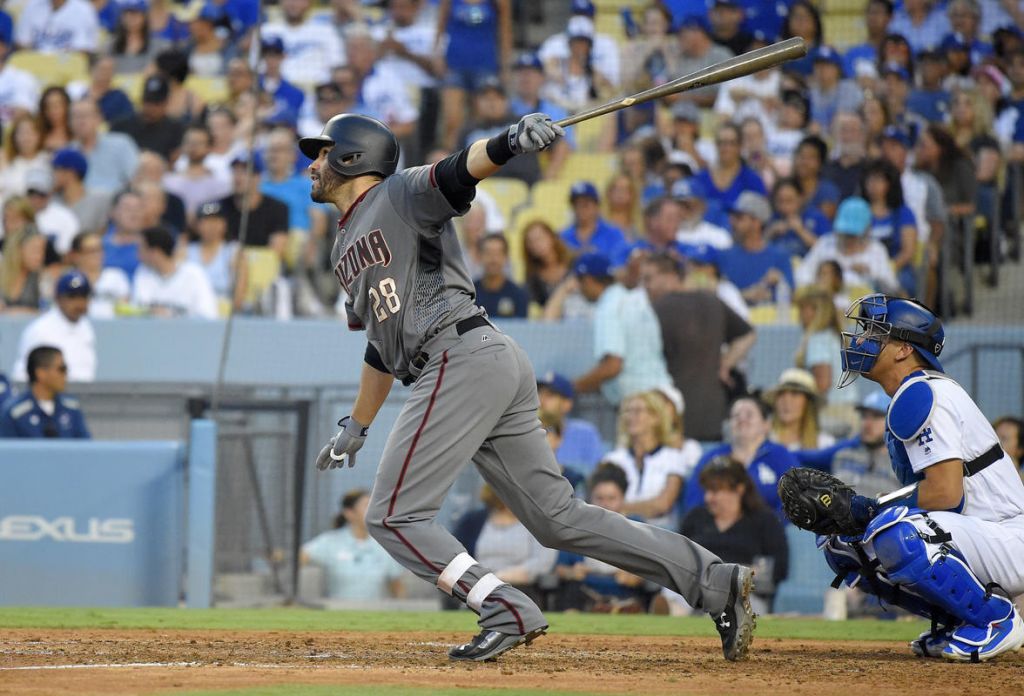 Arizona Diamondbacks&#039 J.D. Martinez right hits a solo home run as Los Angeles Dodgers catcher Austin Barnes watches during the seventh inning of a baseball game Monday Sept. 4 2017 in Los Angeles