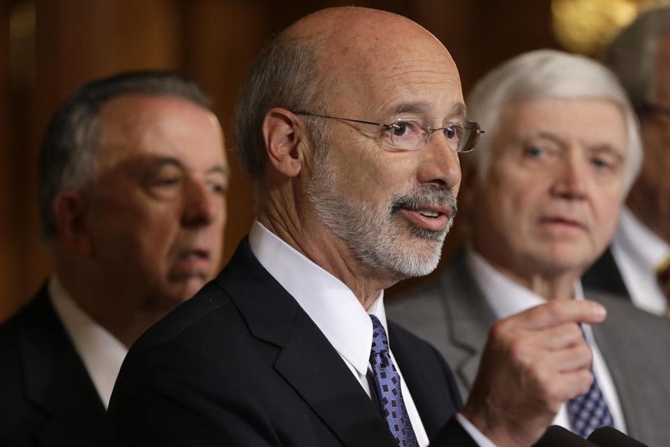 Pennsylvania Gov. Tom Wolf center accompanied by state House Minority Leader Rep. Frank Dermody right D-Allegheny and state Rep. Joe Markosek left D-Allegheny discuss state budget negotiations at the state