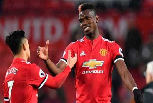 Manchester United stars Alexis Sanchez and Paul Pogba celebrating a goal against Huddersfield