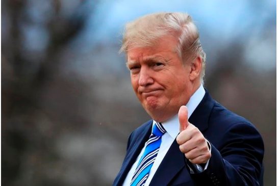 President Donald Trump gestures to the media as he leaves the White House Friday Feb. 16 2018 in Washington for a trip to his private Mar-a Lago resort in Florida