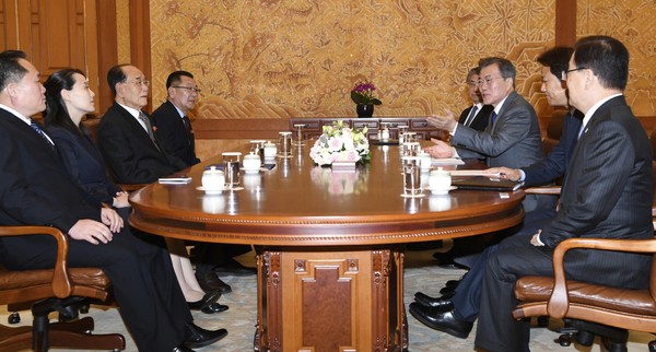 South Korean President Moon Jae-in third from right speaks to Kim Yo Jong second from left sister of North Korean leader Kim Jong Un and North Korean delegation during a meeting at the presidential house in Seoul South Korea Saturday Feb. 10 2018