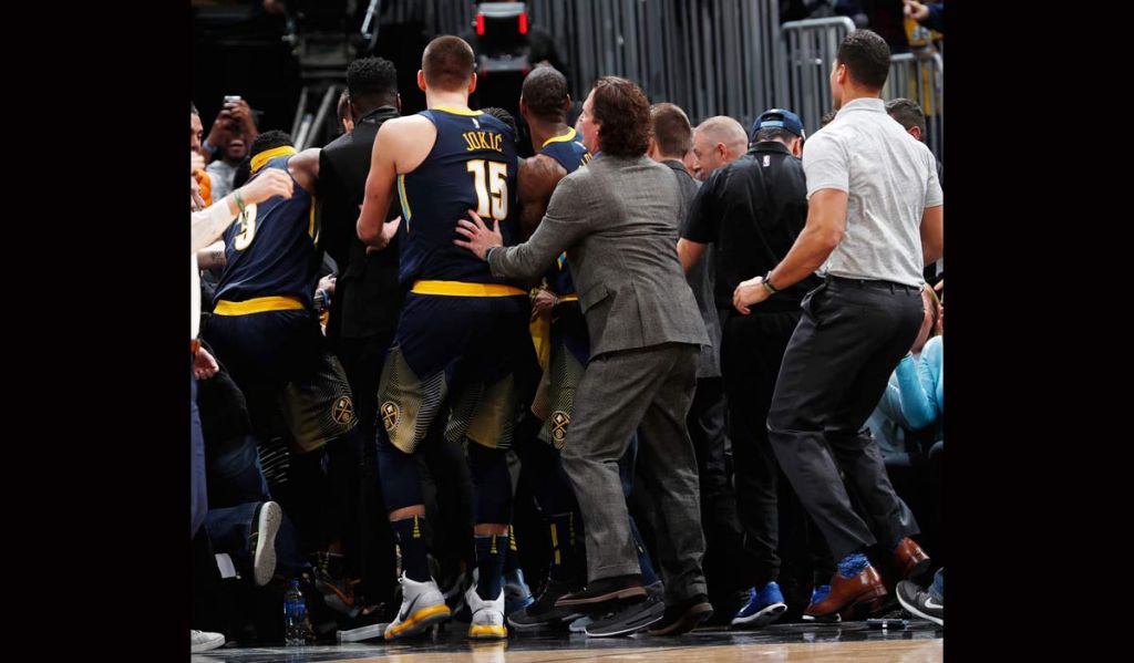 Members of the Denver Nuggets surround guard Gary Harris after he hit a 3-point basket at the final buzzer in the team's NBA basketball game against the Oklahoma City Thunder on Thursday Feb. 1 2018 in Denver