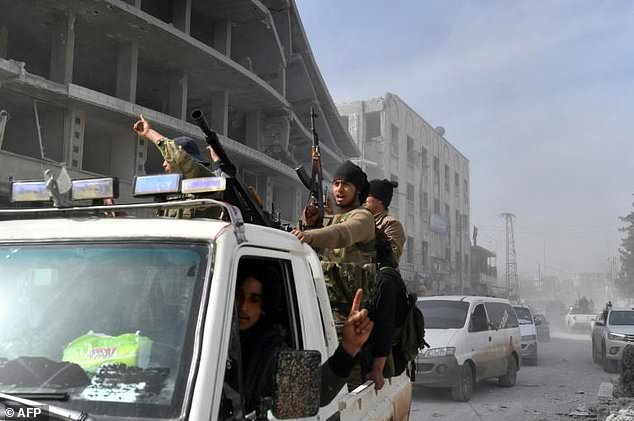 Turkish-backed Syrian rebels drive through the city of Afrin in northern Syria