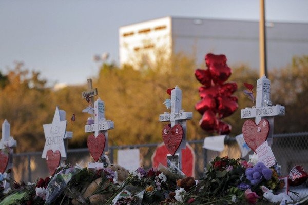 A makeshift memorial is seen outside the Marjory Stoneman Douglas High School where 17 students and faculty were killed in a mass shooting on Wednesday in Parkland Fla. Monday Feb. 19 2018. Nikolas Cruz a former student was charged with 17 counts