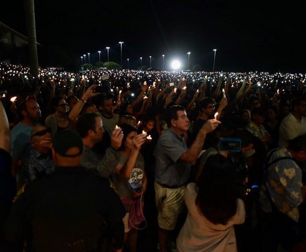 Community members gather for a vigil in Parkland Florida in honor of the 17 victims of Wednesday's massacre at Douglas High School