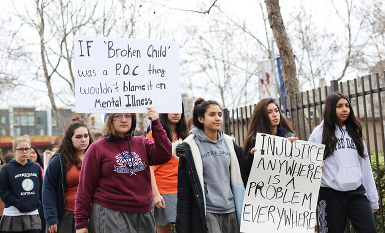 Notre Dame High students held up signs demanding change