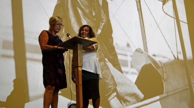 PAYING TRIBUTE Anna Goos speaking to the audience with June Reimer during the CRANES International Women's Day celebration