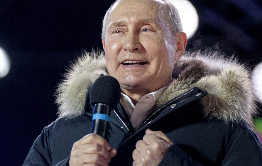 Russian President Vladimir Putin waves after speaking to supporters during a rally near the Kremlin in Moscow