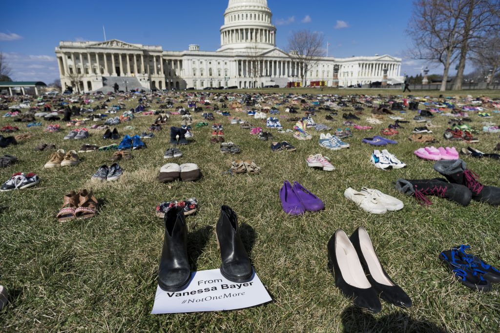 7,000 empty pairs of children's shoes representing the children killed with a gun since the Sandy Hook massacre is displayed on the lawn outside the U.S. Capitol.'The display is intended to put pressure on lawmakers, says Oscar Soria spokesman for the