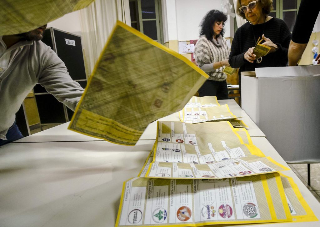 Scrutineers count votes in a polling station in Rome