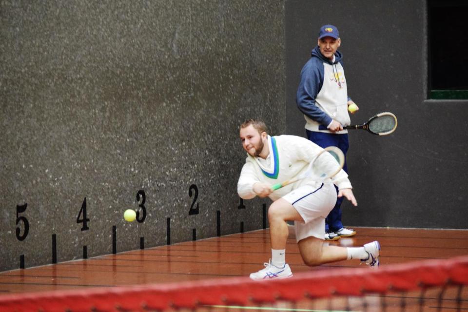 One. Hamilton's Trevor Jones a sophomore at Salve Regina University returns a shot under the watchful eye of his court tennis coach Mike Gooding at the National Tennis Club in Newport R.I. Ed Habershaw  Salve Regina