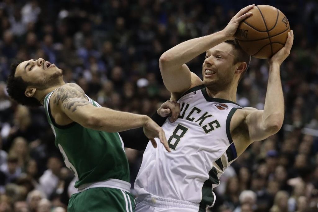 ROUGHED UP Shane Larkin takes an elbow from the Bucks’ Matthew Dellavedova during the Celtics’ 116-92 loss in Game 3 last night in Milwaukee