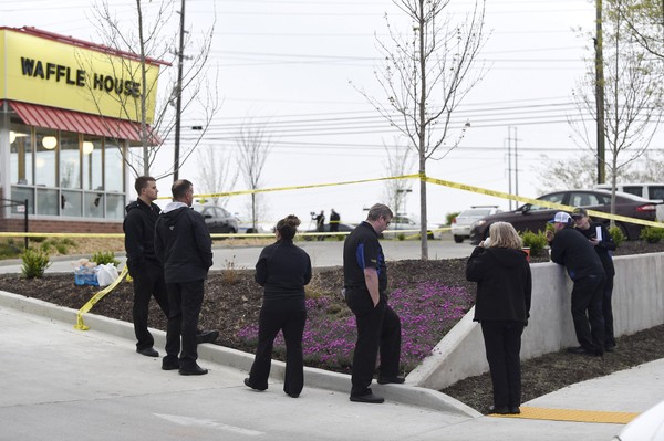 Law enforcement officials work the scene of a fatal shooting at a Waffle House in the Antioch neighborhood of Nashville Sunday