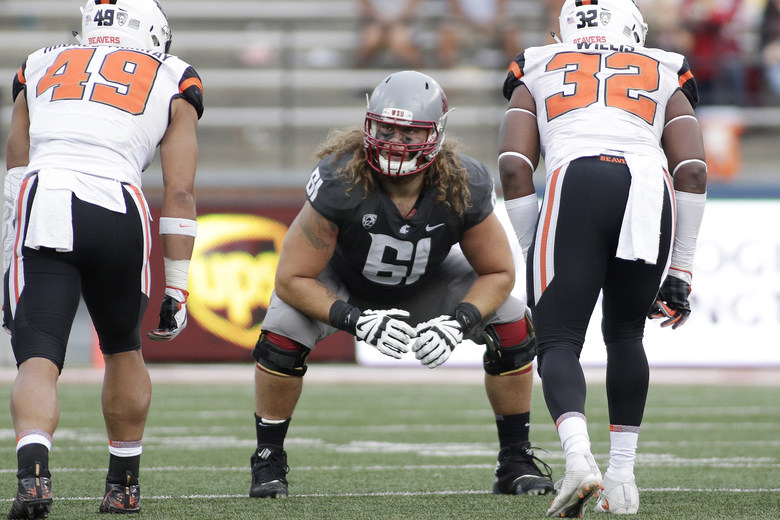 Washington State offensive lineman Cole Madison lines up for a play during the second half of an NCAA college football game against Oregon State in Pullman Wash. Madison was selected to the AP All-Confer