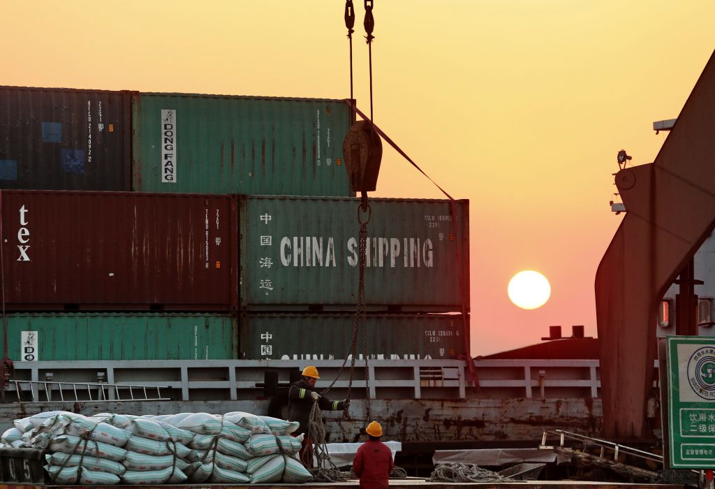 Workers loading ships at a port in Nantong in China's eastern Jiangsu province