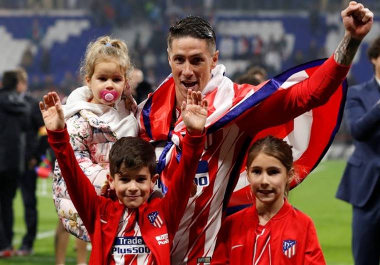 Atletico Madrid’s Fernando Torres celebrates with children after winning the Europa League