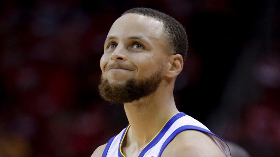 Golden State Warriors guard Stephen Curry reacts after getting called for a foul against the Houston Rockets during the second half in Game 5 of the NBA basketball playoffs Western Conference finals in Houston