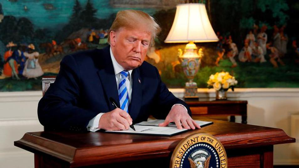 U.S. President Donald Trump signs a proclamation declaring his intention to withdraw from the JCPOA Iran nuclear agreement in the Diplomatic Room at the White House in Washington