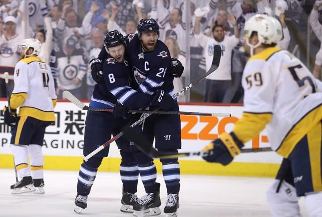 Winnipeg Jets&#39 Jacob Trouba and Blake Wheeler celebrate after Trouba scored against the Nashville Predators during second period NHL hockey playoff action in Winnipeg Tuesday