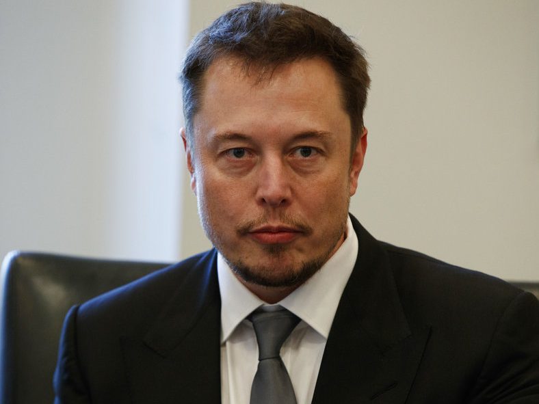 Tesla CEO Elon Musk listens as President-elect Donald Trump speaks during a meeting with technology industry leaders at Trump Tower in New York