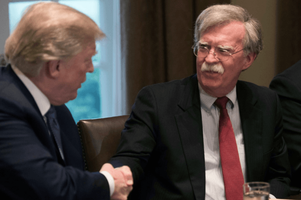 President Donald Trump shakes new National Security Adviser John Bolton’s hand during a meeting with top military advisers