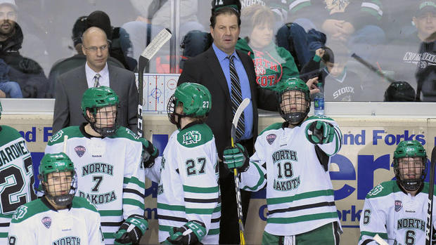 UND coach Brad Berry behind the Fighting Hawks&#039 bench