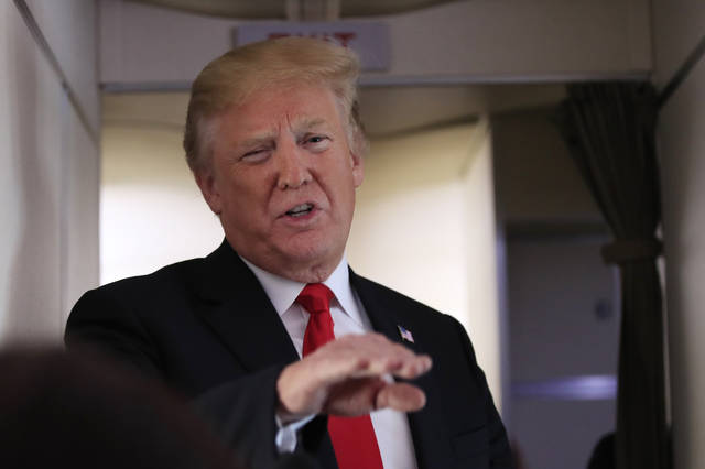 ASSOCIATED PRESS           President Donald Trump speaks to reporters onboard Air Force One on his way to Bedminster N.J. today