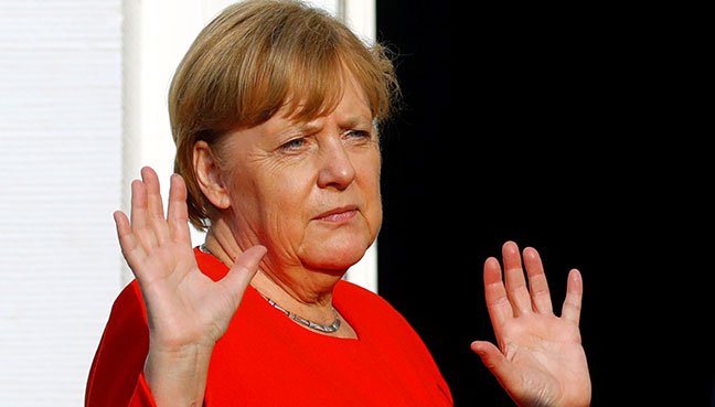 German Chancellor Angela Merkel gestures as she welcomes representatives of the European Round Table of Industrialists in Meseberg