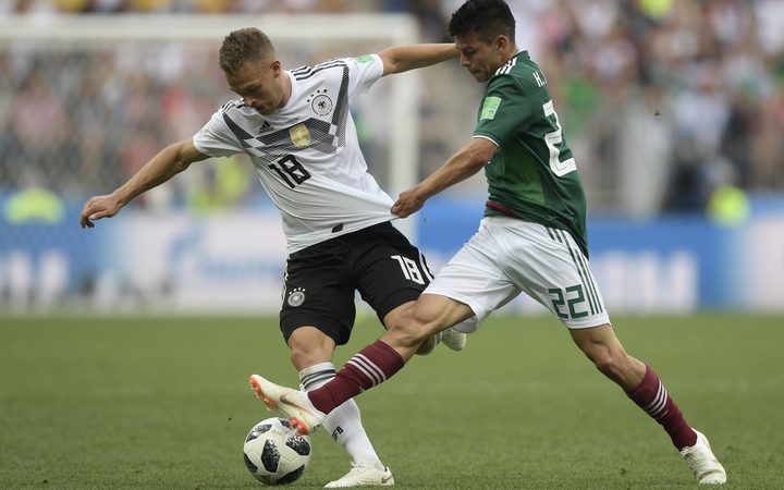 Germany's Joshua Kimmich and Mexico's Hirving Lozano compete for the ball