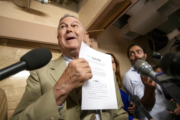 Rep. Dana Rohrabacher R-Calif. speaks to reporters as he emerges from a closed-door meeting on Capitol Hill where House Republicans are trying to bridge their party's internal struggle over immigration in Washington Thursday