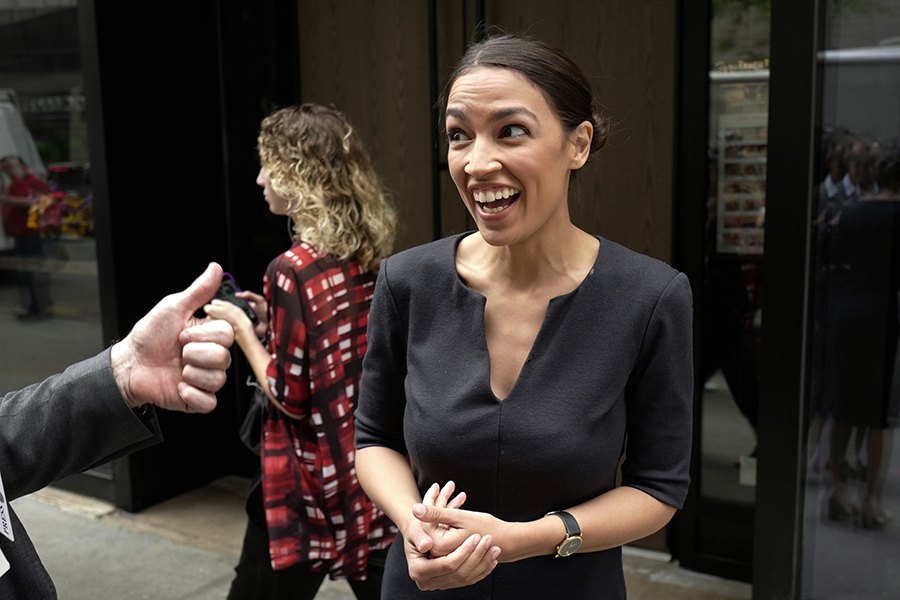 Alexandria Ocasio-Cortez the winner of a Democratic Congressional primary in New York reacts while talking to the media Wednesday