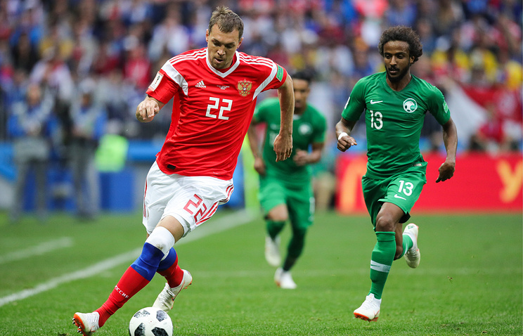 Russia's Artyom Dzyuba and Saudi Arabia's Yasser Al Shahrani in action in the 2018 FIFA World Cup opening match at Luzhniki Stadium