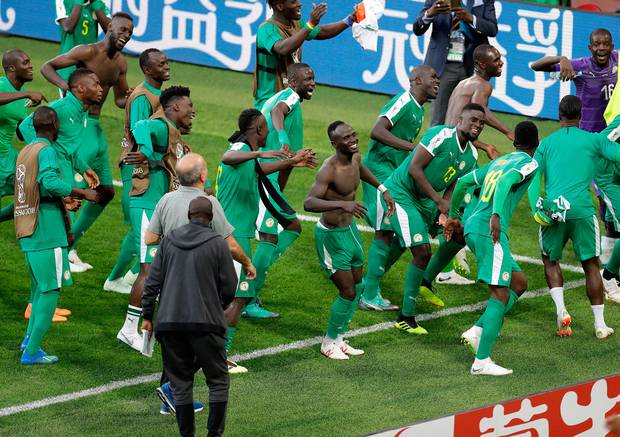 Senegal players celebrate after the group H match between Poland and Senegal at the 2018 soccer World Cup in the Spartak Stadium in Moscow Russia Tuesday