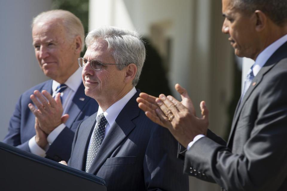 Federal appeals court judge Merrick Garland center stands as President Barack Obama right and Vice President Joe Biden applaud as he is introduced as Obama’s nominee for the Supreme Court in the Rose Garden of the White House on Wednesday March