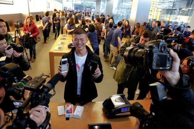 The first customer shows his new iPhone X after buying it at an Apple Store in Beijing China Nov 3 2017